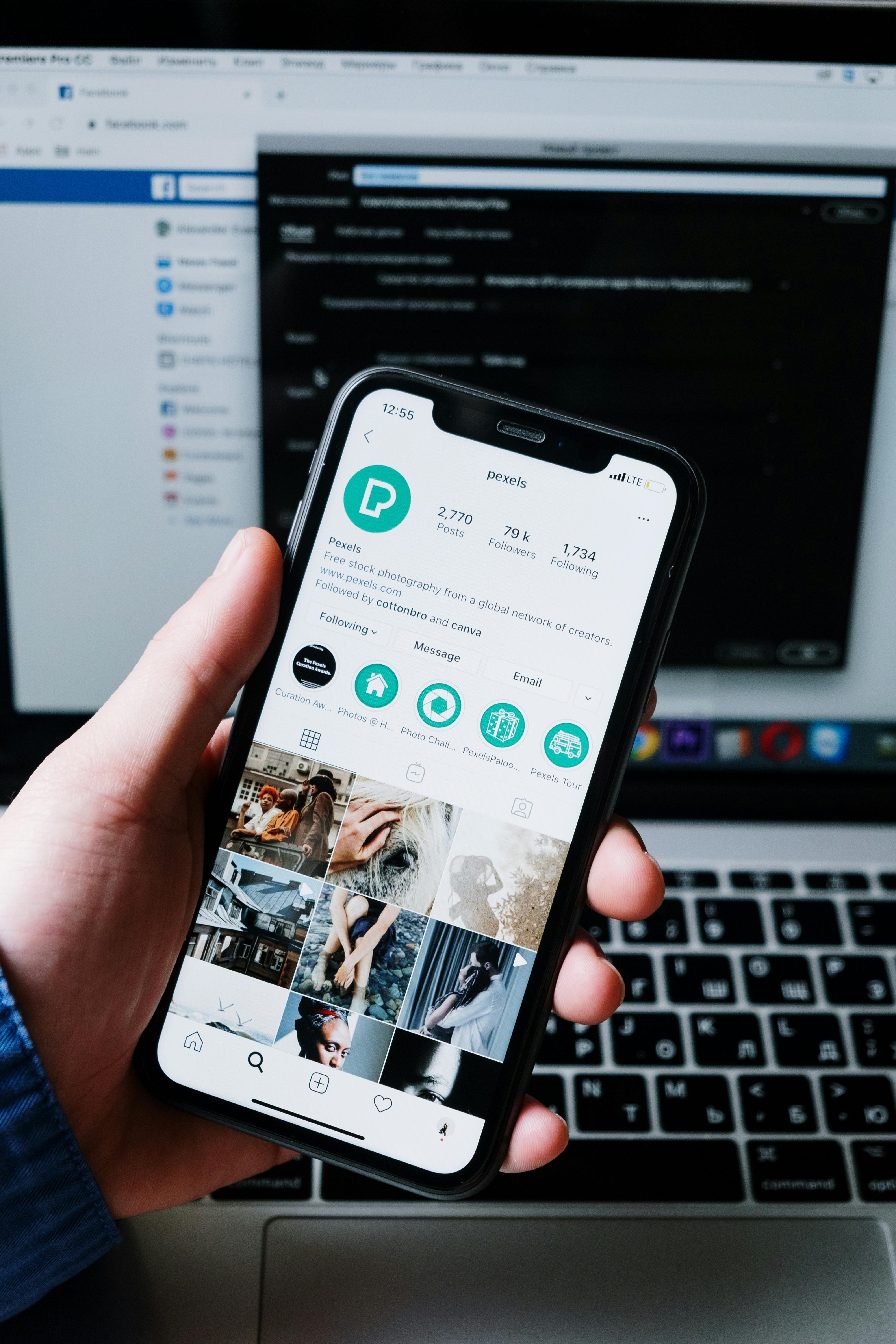 Hand holding a smartphone with a social media app